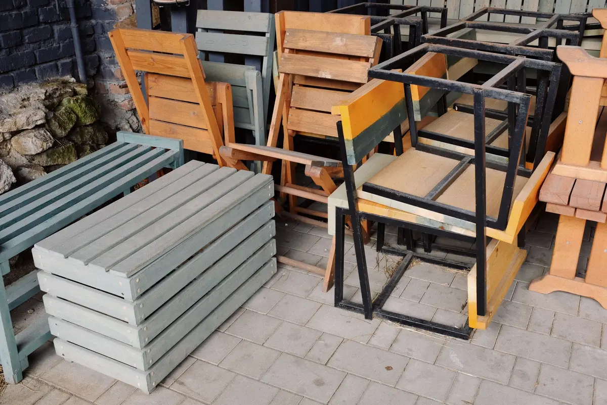 Trois tables de jardin en diff&eacute;rents mat&eacute;riaux : bois, m&eacute;tal et plastique