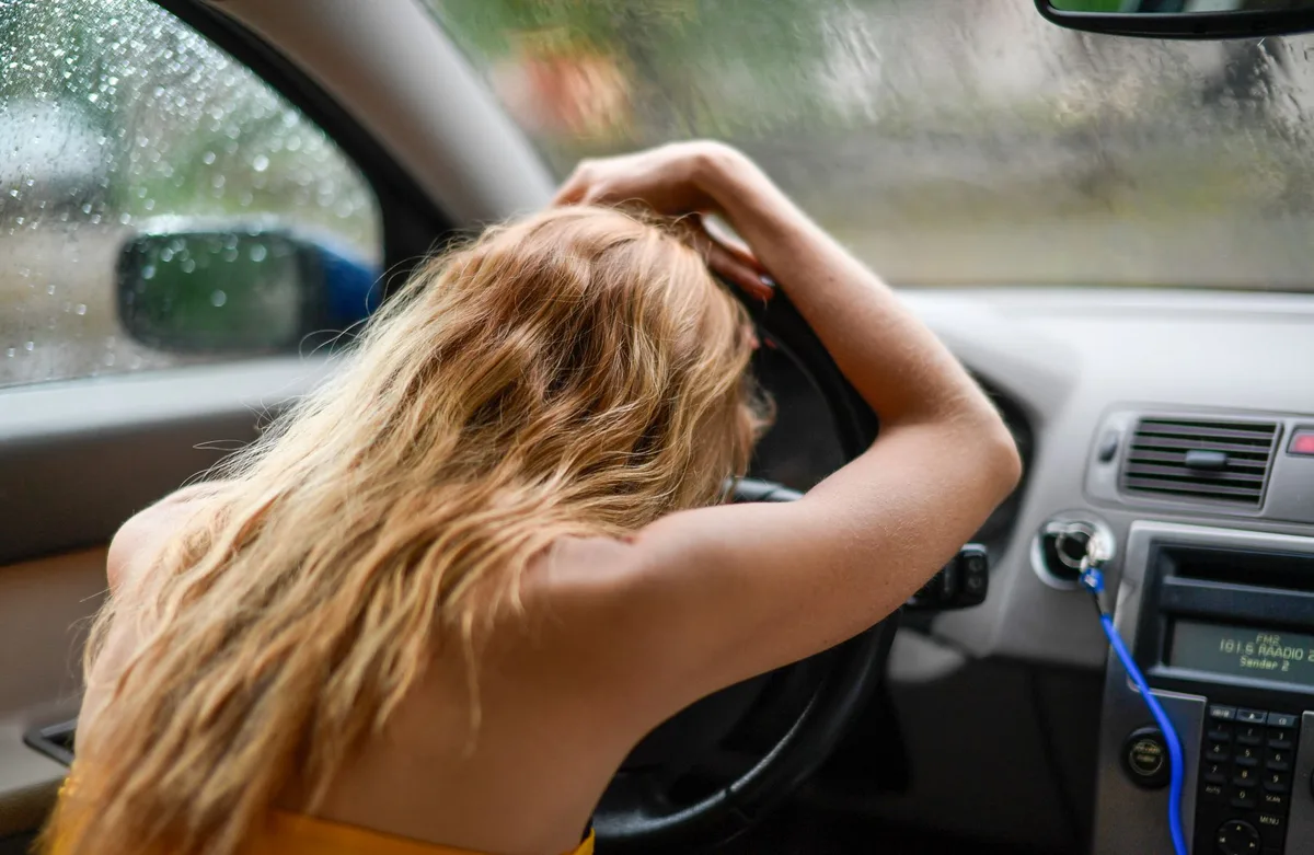Conducteur prenant une respiration profonde pour gérer le stress avant l'examen