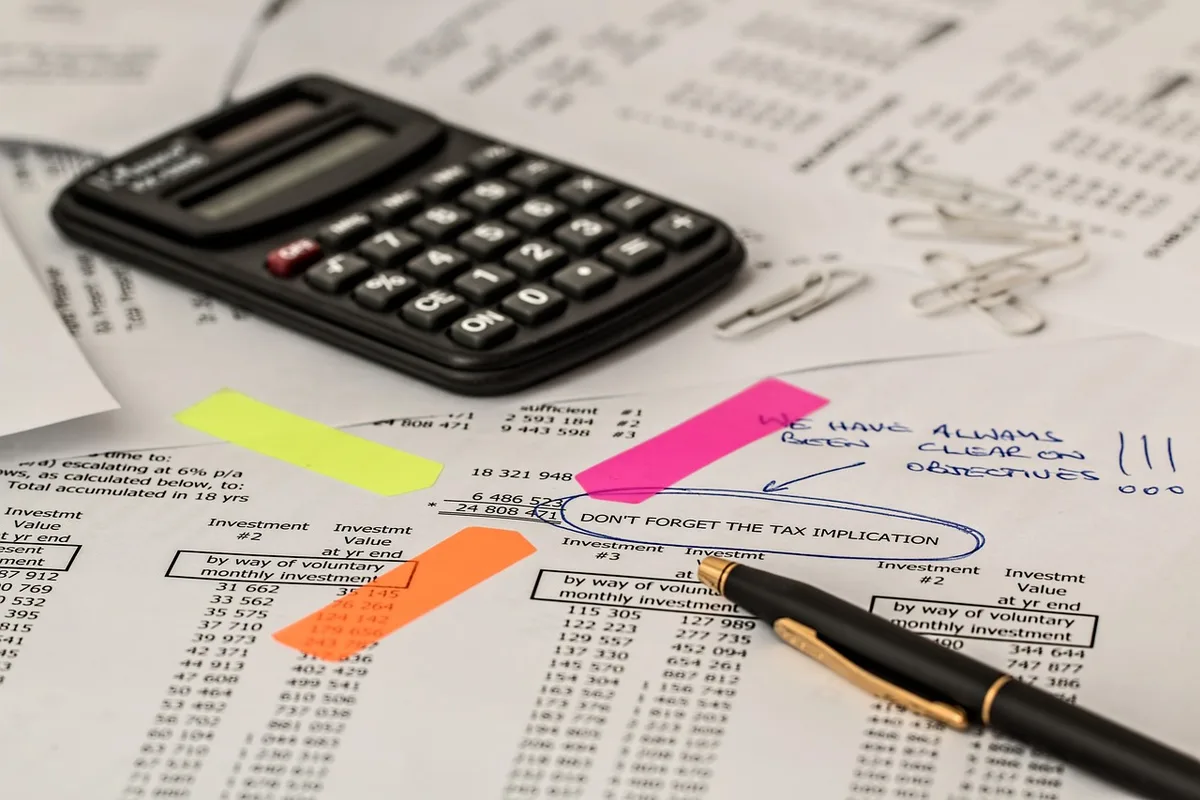 Formulaire de demande de prêt immobilier avec calculatrice et graphique de hausse sur un bureau
